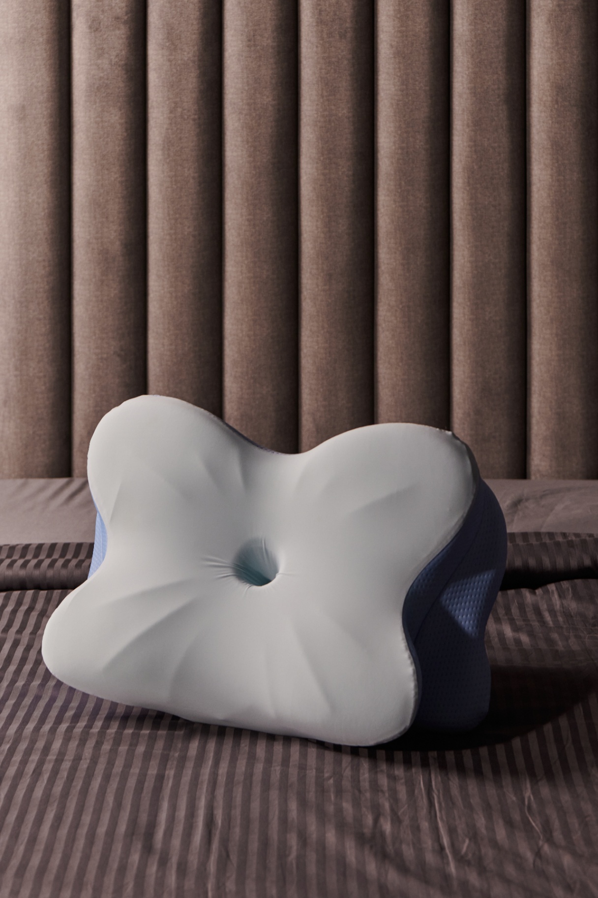 Memory foam pillow shown from the front on a bed